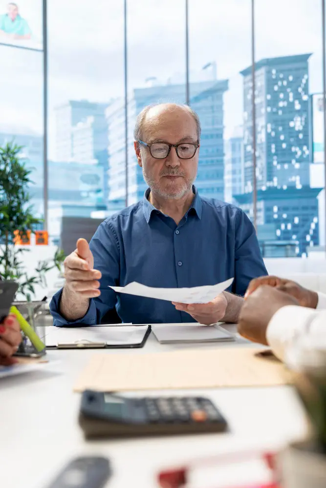 Senior people negotiating with a financial banker to develop a pension plan