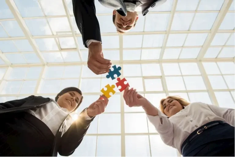 A group of diverse professionals working together on a project, symbolizing team building through collaboration and unity.