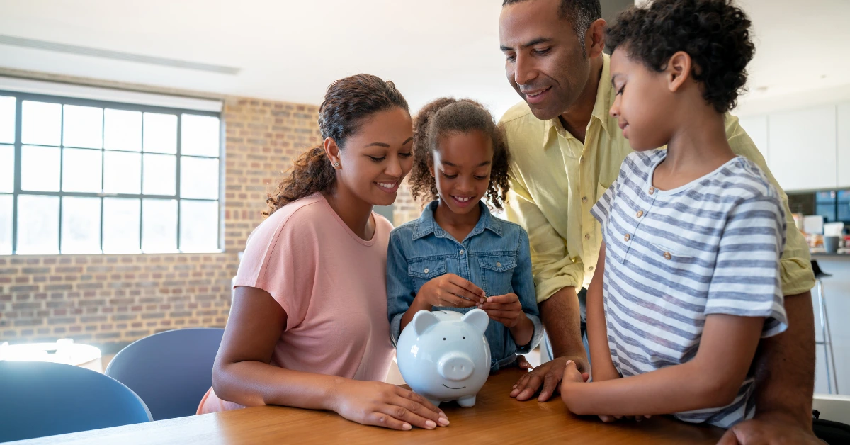Family teaching children to save money, symbolizing financial education across generations